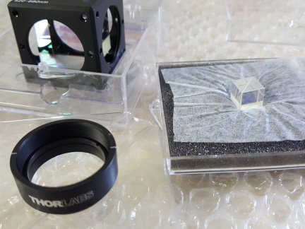 Icon Optical elements for laser excitation of ions in a linear trap